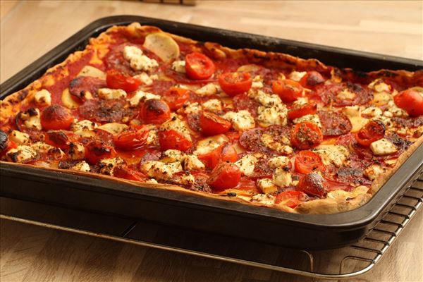 Pizza with sausages, potatoes and feta